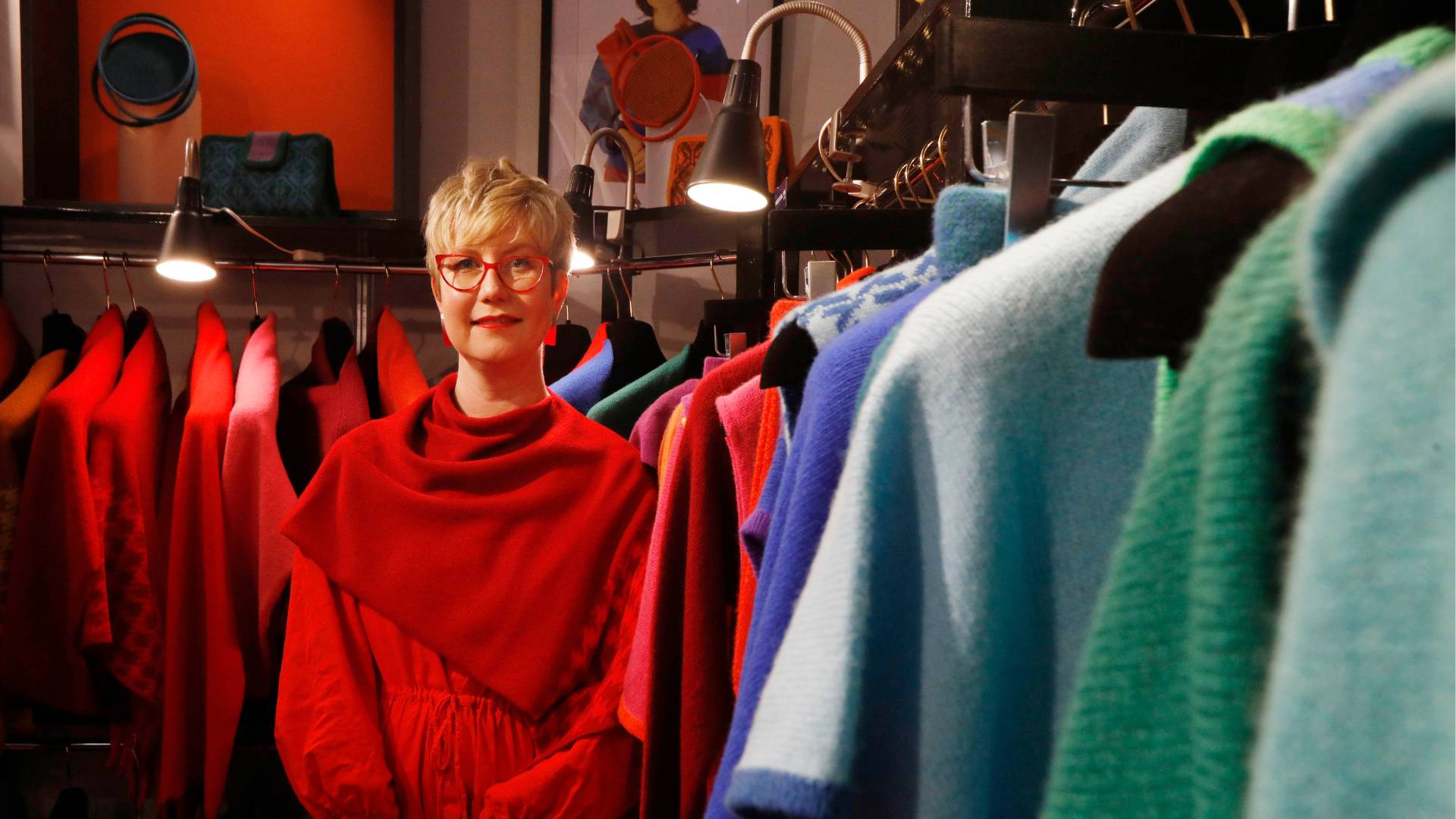 Designer Michelle McCarroll stands among her knitwear