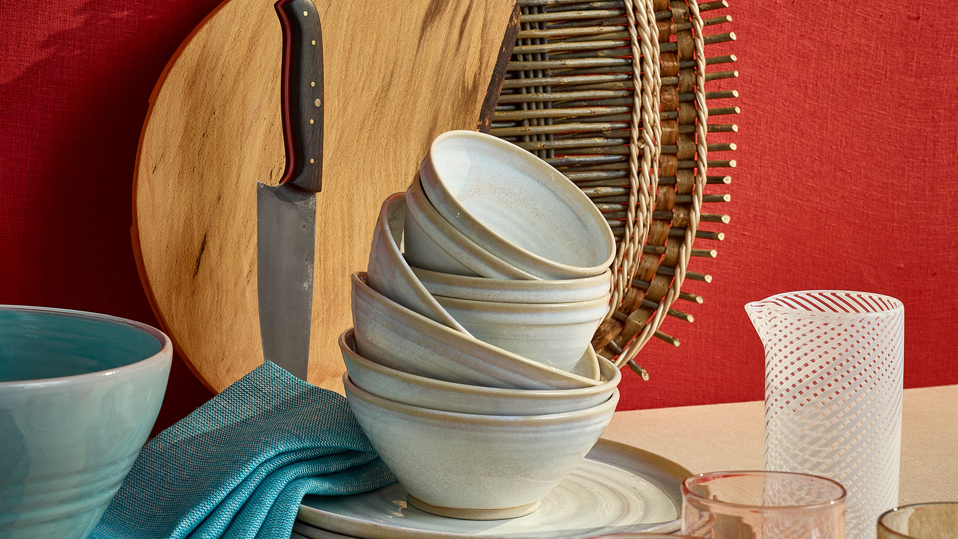 DCCI Made Local presents: Saille Baskets, Oval 'catalan' platter with willow bark ribbon detailing Ballyshane, Irish Beech Medium Cheese/Bread/Serving Board Smyth Knives, Carbon + Irish oak slicer / chopper Helen Faulkner, Serving Bowl, handmade glazed terracotta with soft turquoise glaze and Dinner plate, handmade glazed terracotta with soft turquoise glaze McNutt of Donegal, Linen napkins, set of 4, Turquoise Ceramifique, Sky bowl Rosemarie Durr Pottery, Stacking range in buttermilk white glaze, pieces from Benefield Spencer Glass, Filigrana pouring cylinder Jerpoint Glass Studio Ltd, Monocrome beakers in copper and olive [each] © Trevor Hart